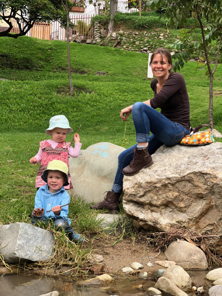 Day in the life: stopping to throw rocks on the way home from the kids' Ecuador preschool. 